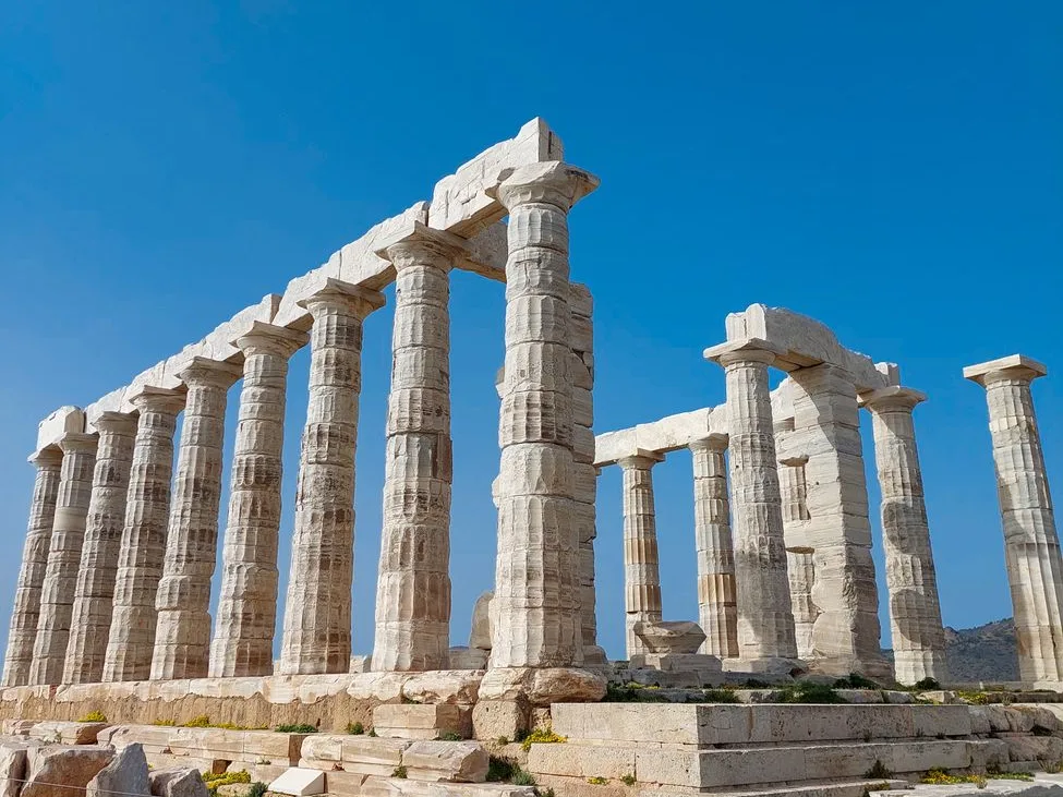Colonnes doriques en marbre blanc du temple de Poséidon au cap Sounion sous un ciel bleu