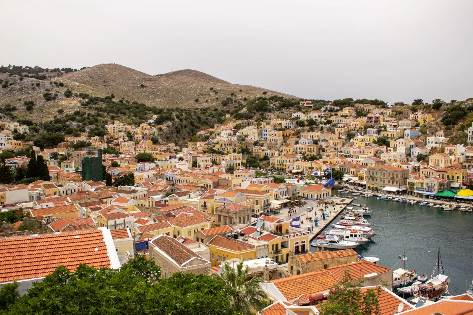 Le port de Gialos à Symi, avec ses maisons néoclassiques ocre et rouges étagées en amphithéâtre autour du bassin