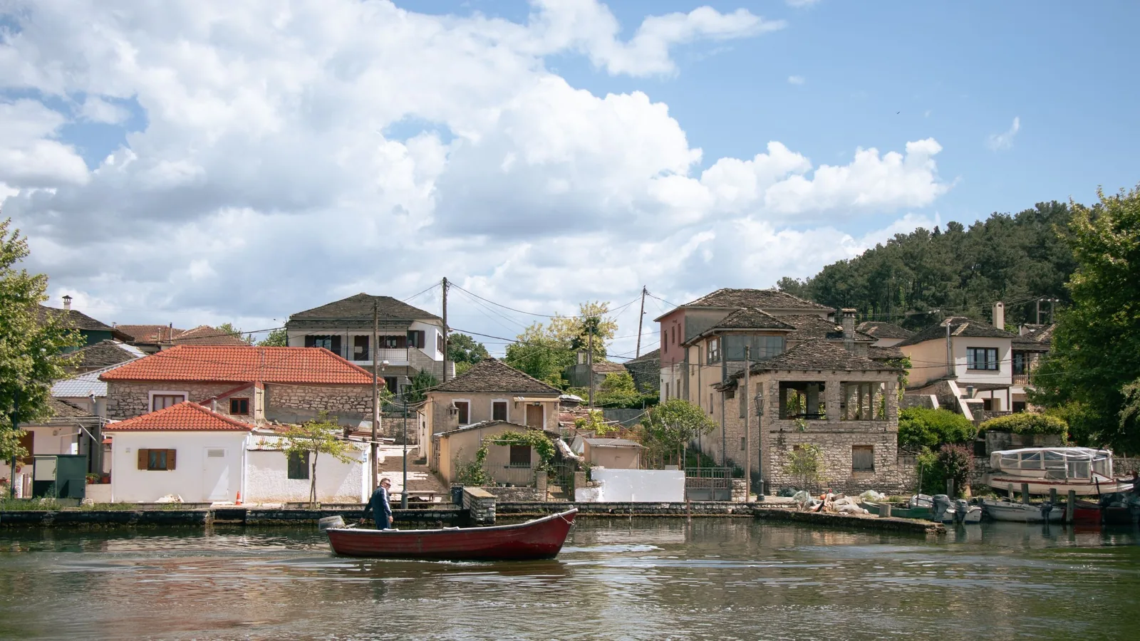 Maisons au bord de l'eau et barque sur la rive du lac d'Ioannina